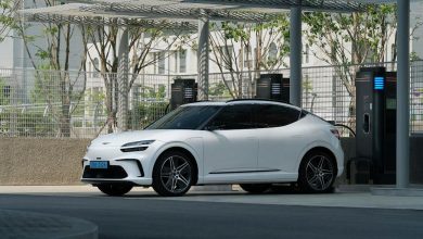 white electric suv charging at outdoor station